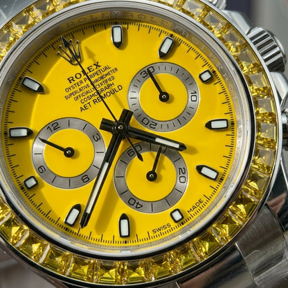 Macro of the yellow dial, silver counters and square-cut yellow stone bezel